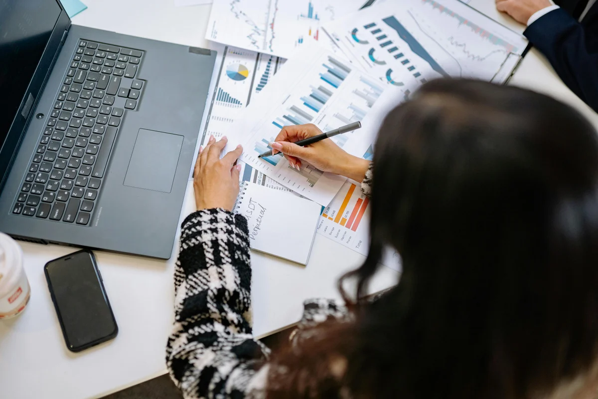 Professional analysing compliance costs comparing AI automation to manual processes