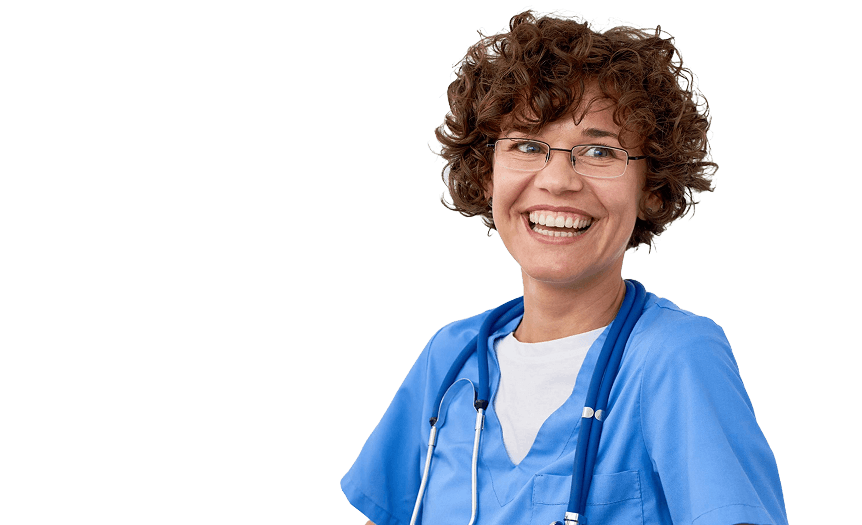 A person wearing blue medical scrubs and glasses, smiling, with a stethoscope around their neck against a plain background.