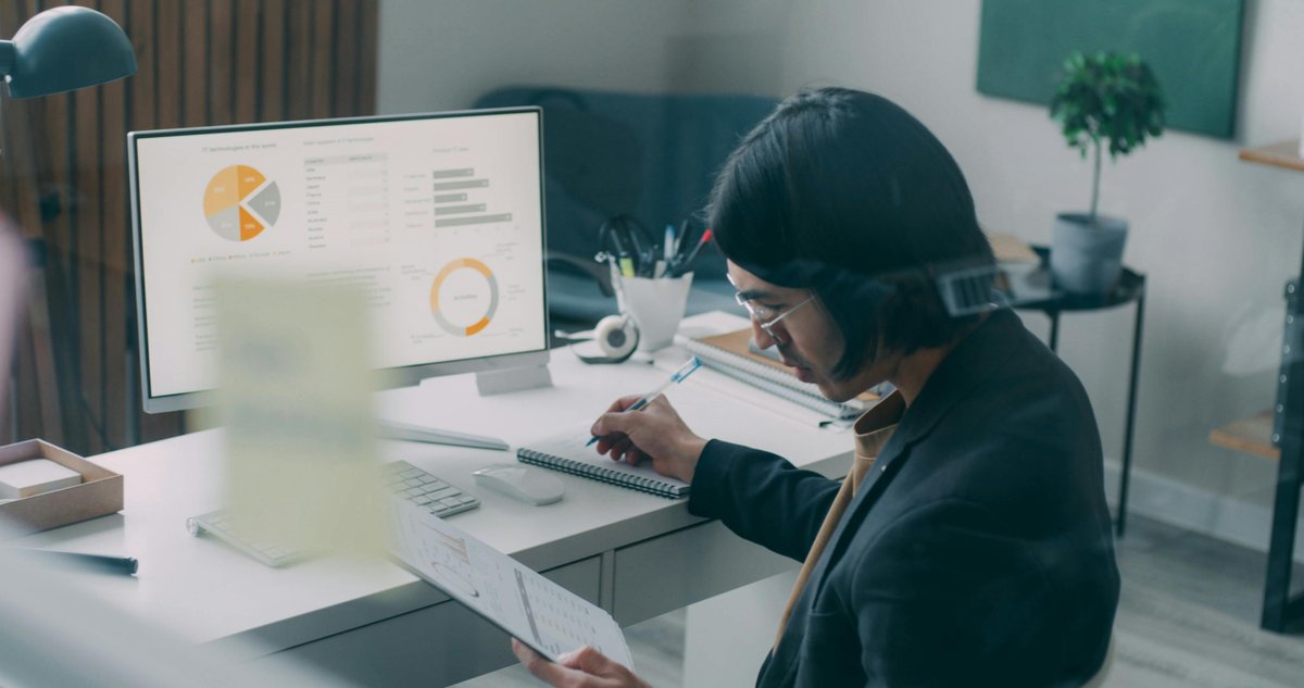 Business professional reviewing compliance analytics and charts on dashboard