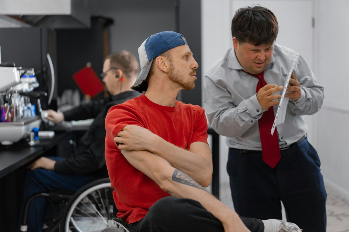 Diverse team collaborating in inclusive office setting for NDIS compliance