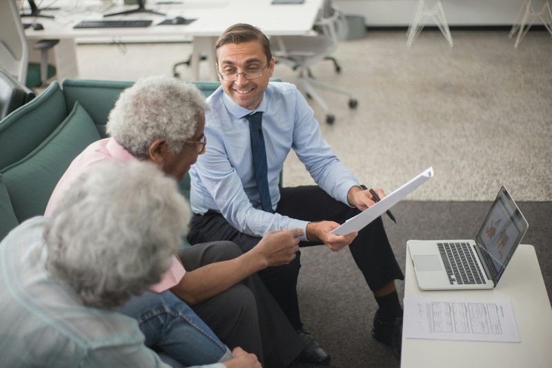 Consultant discussing financial plans with multiple clients demonstrating scalability
